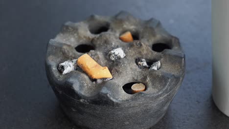 used ashtray with cigarette butts