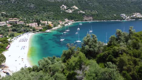 revealing aerial over mikros poros gialos beach bay cliff, lefkada, greece