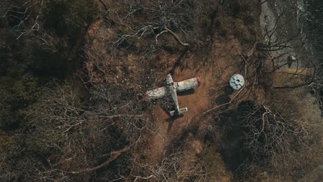 establishing shot of abandoned small airplane stuck on the top of a hill by the coast in costa rica, province of guanacaste 4k aerial drone straight ascent with rotation