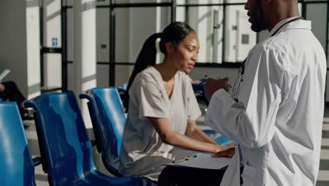 doctor consulting patient in hospital waiting room