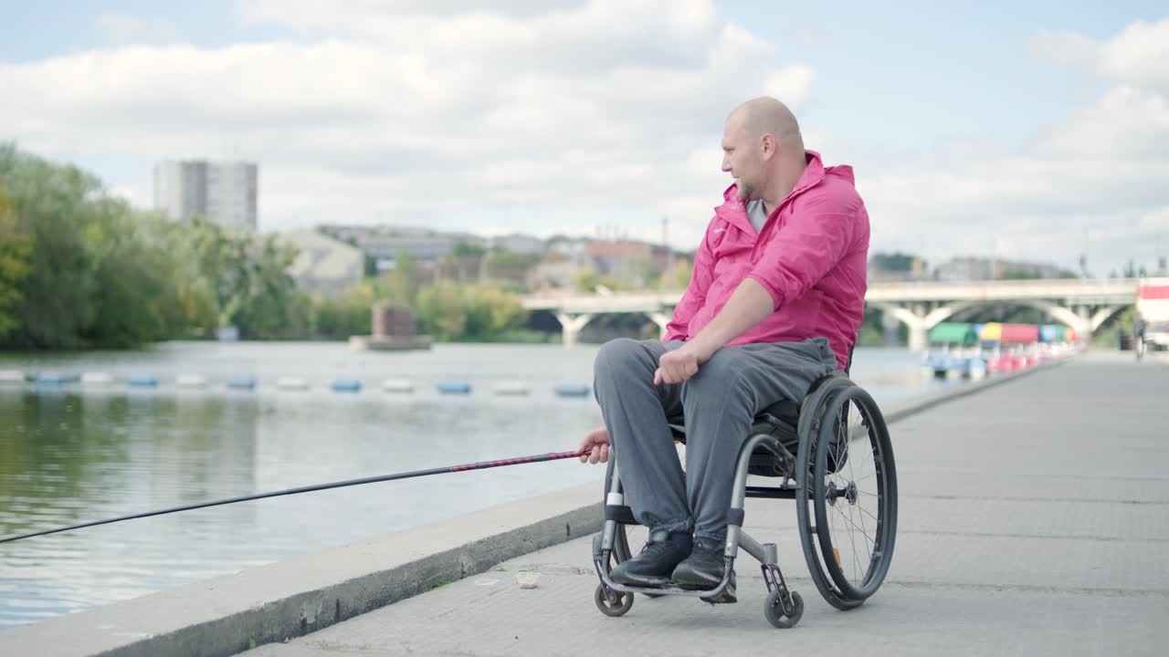 Person with a physical disability who uses wheelchair fishing from fishing pier