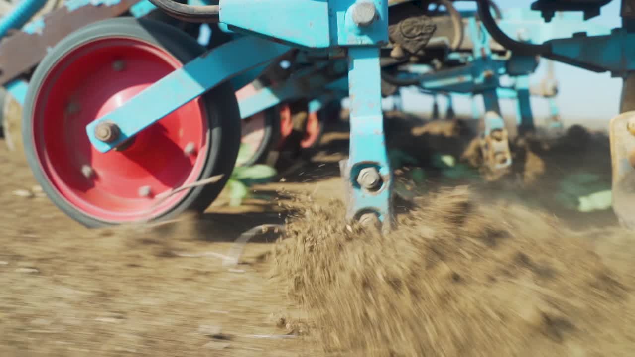 Plow in the ground, plowing in slow motionSuper close up shotcultivator