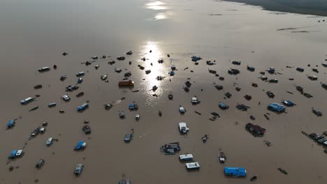 aerial shot of tonle sap, cambodia, reveals a floating village filled with houses on the water