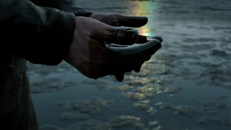 hands covered in dripping oil, symbolizing environmental pollution