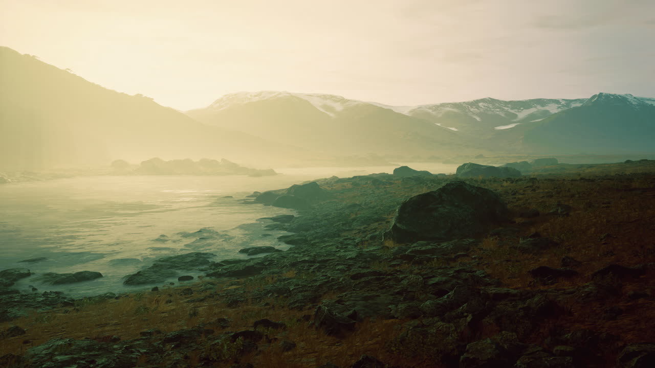 Majestic mountains reflect in tranquil waters at sunset in remote wilderness