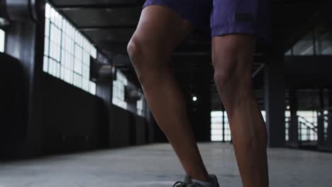 African-american-man-skipping-the-rope-in-an-empty-urban-building