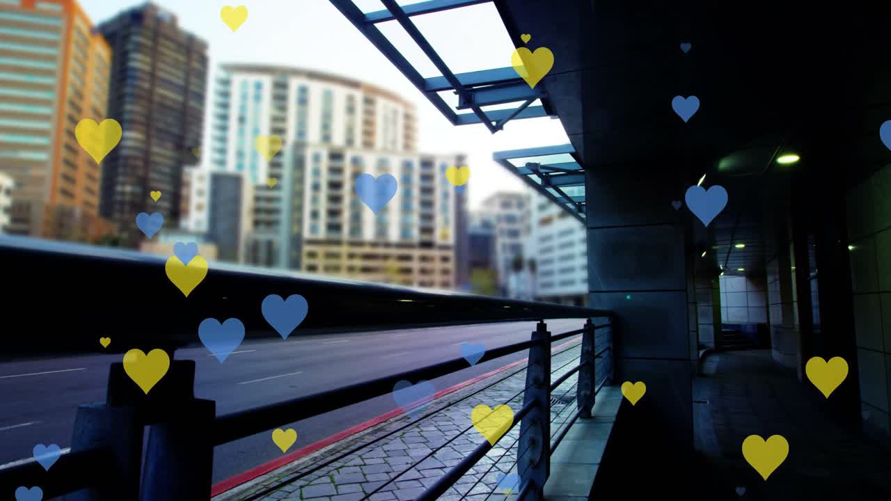 도시 풍경 위에 떠다니는 노란색과 파란색의 심장의 애니메이션