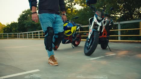 close-up shot of a biker rides with a motorcyclist helmet along motorcycles in a motorcycle school. motorcycle training ground