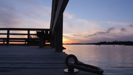 jetty at sunset near calm and peaceful lake in sweden