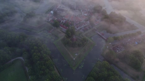 Magical-foggy-morning-at-star-shaped-Fort-Bourtange-in-Holland,-aerial
