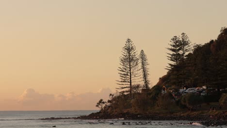 Long-view-of-Burleigh-Heads-from-the-beach-at-sunrise,-Gold-Coast,-Queensland,-Australia