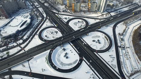 Car-traffic-freeway-overpass-at-winter.-Aerial-cars-moving-on-highway-junction