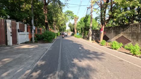 a vehicle's perspective of a suburban road