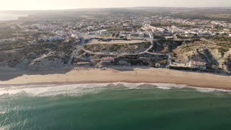 dolly out aerial seascape of the secluded cove and beach in sagres algarve portugal