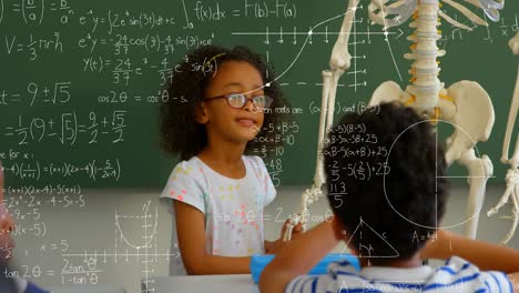 Mathematical-equations-floating-against-girl-touching-human-skeleton-in-class