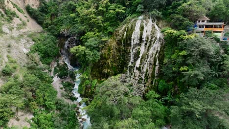 panoramic drone orbit flight overlooking the mezquital canyon, la gloria waterfall and the la gloria resort at tolantongo, mexico