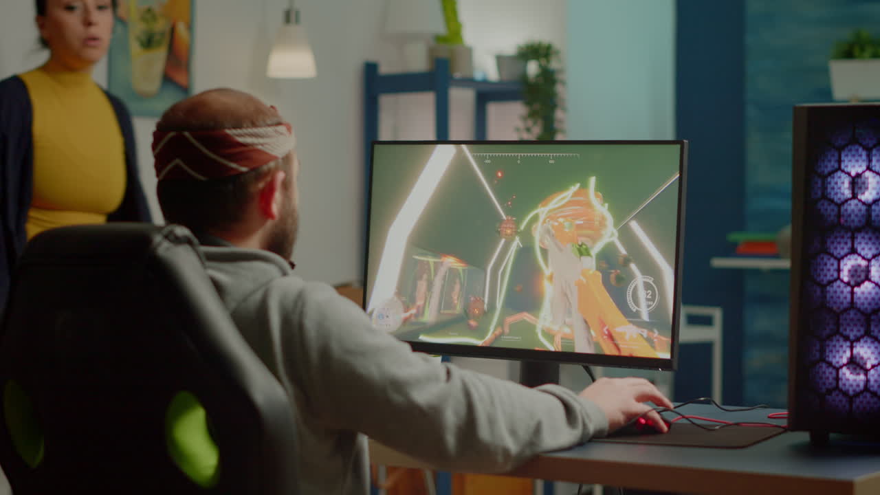 Nervous woman screaming at husband while he is playing videogame