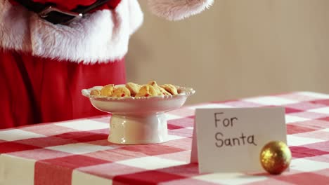 mid-section of santa claus having milk and breakfast