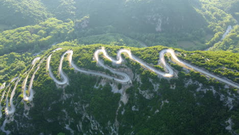 view of serpentine narrow road leading to vikos gorge in northern greece