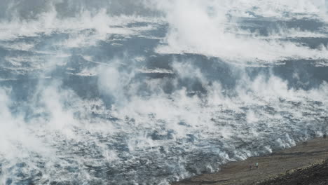 tourists in front of a massive cooling lava field