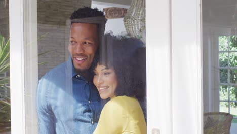 happy african american couple embracing together at home