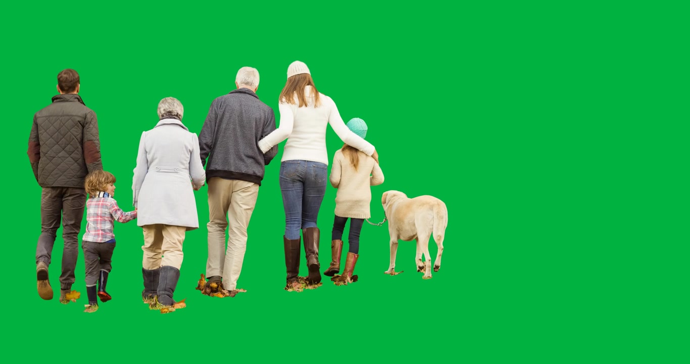 Rea view of two generation family walking their dog against black background