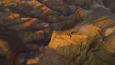 Man-Standing-On-The-Edge-Of-The-Cliff,-Tsagaan-Suvarga-In-Mongolia---Aerial-Drone-Shot