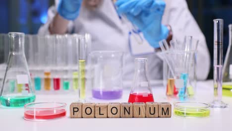 scientist conducting experiments in a lab with chemical glassware and the word polonium