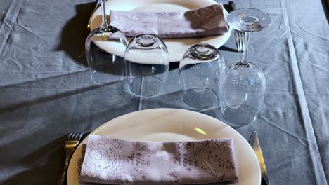 low lighting dining room dressed up with cotton clothing and leather chairs