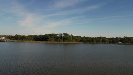 Aerial-reverse-reveal-of-sunken-boat-on-a-dock-in-Alabama