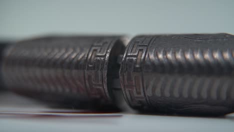 a macro shot of two ancient silver knifes smooth opening, chinese antique weapon, historical vintage blade, old textured steel, traditional dagger, professional lighting, cinematic slow motion 120 fps