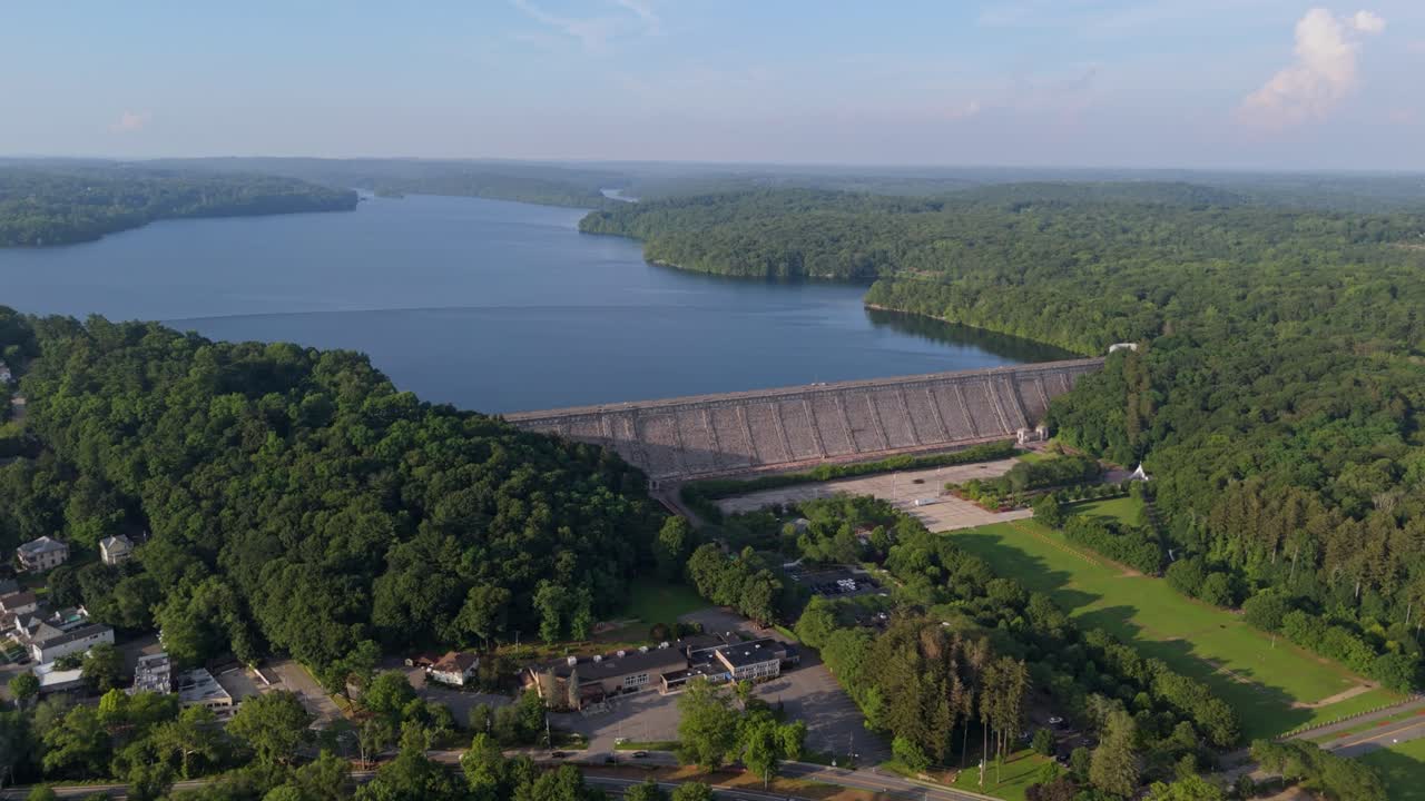 Kensico Dam and Reservoir, town of Valhalla below, surrounded by green summer forest in Westchester County, New York, USA