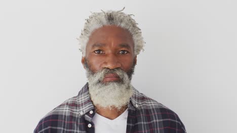 senior man smiling against white background