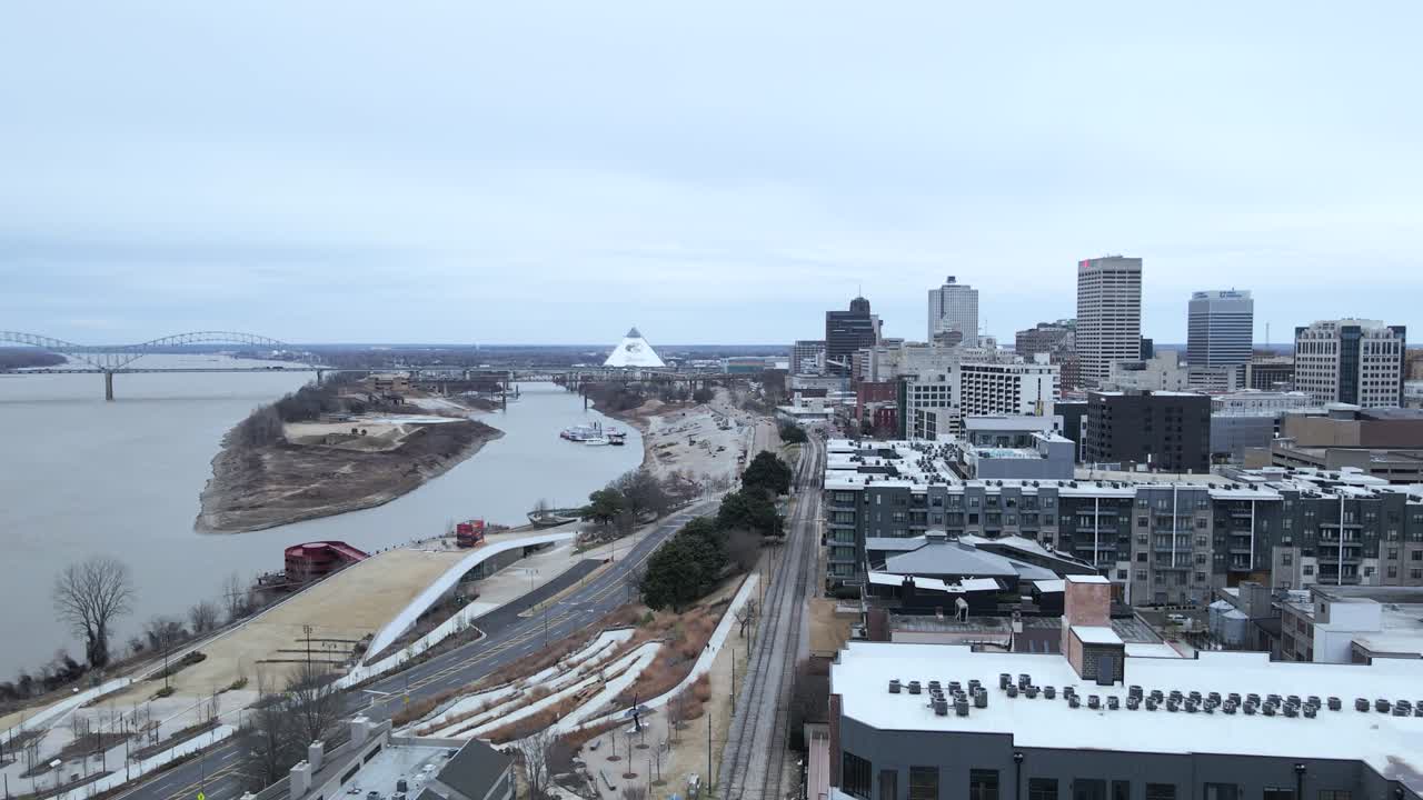 Drone aerial shot of downtown Memphis, Tennessee, showing the Mississippi River and the iconic pyramid in the background