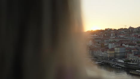 a tourist taking photos of the sunset in the city of porto, in portugal