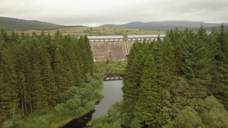 aerial view of clatteringshaws dam in dumfries and galloway forest park, scotland