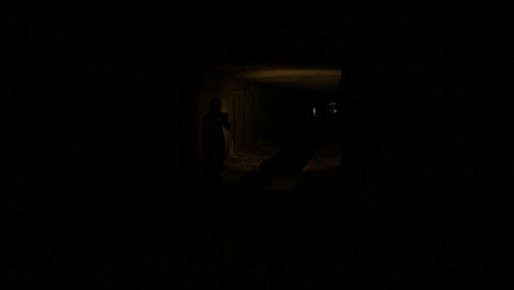 dark underground tunnel with person