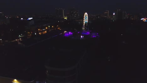 night city aerial view with ferris wheel