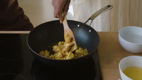 cooking chicken stir-fry in a wok