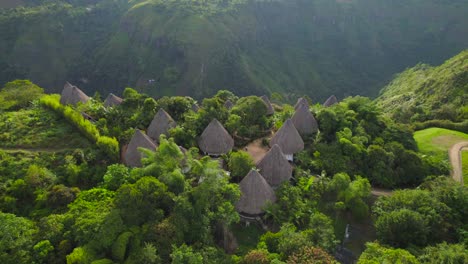 wooden hut eco-hotel on the edge of a canyon jungle in colombia at sunset