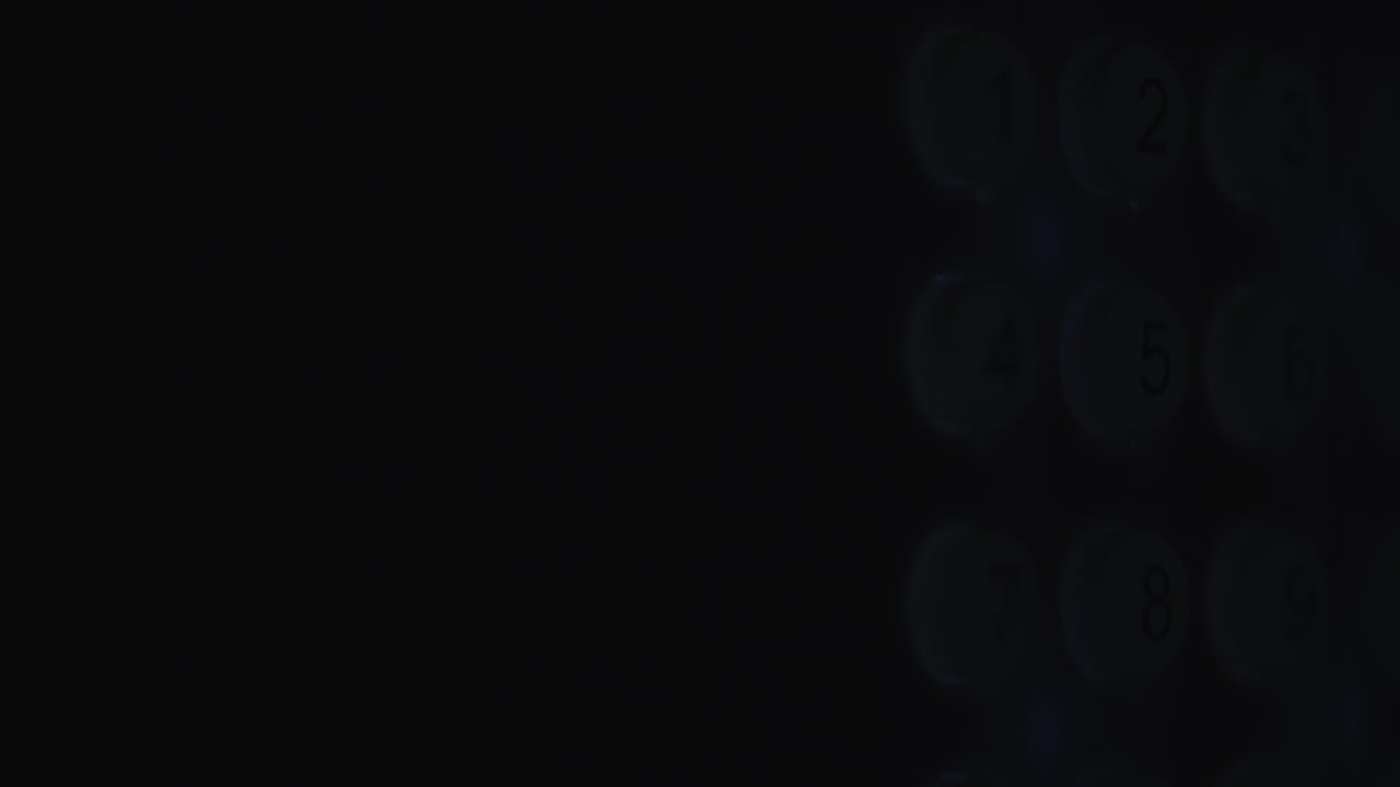 A person enters a pin code on a backlit keyboard