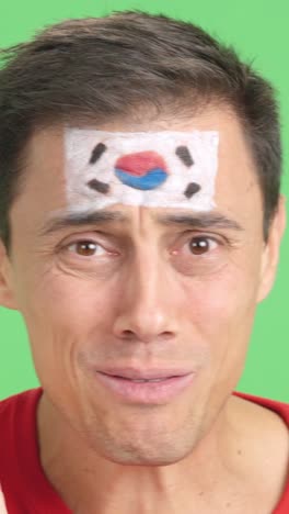 very nervous man supporting south korean team during a difficult match