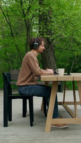 man working outdoors on a laptop