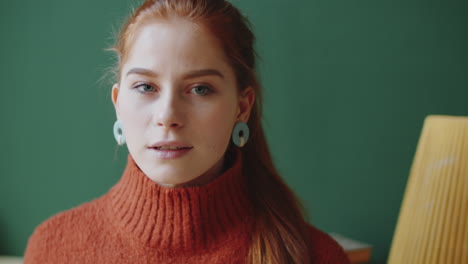 woman with red hair and orange sweater