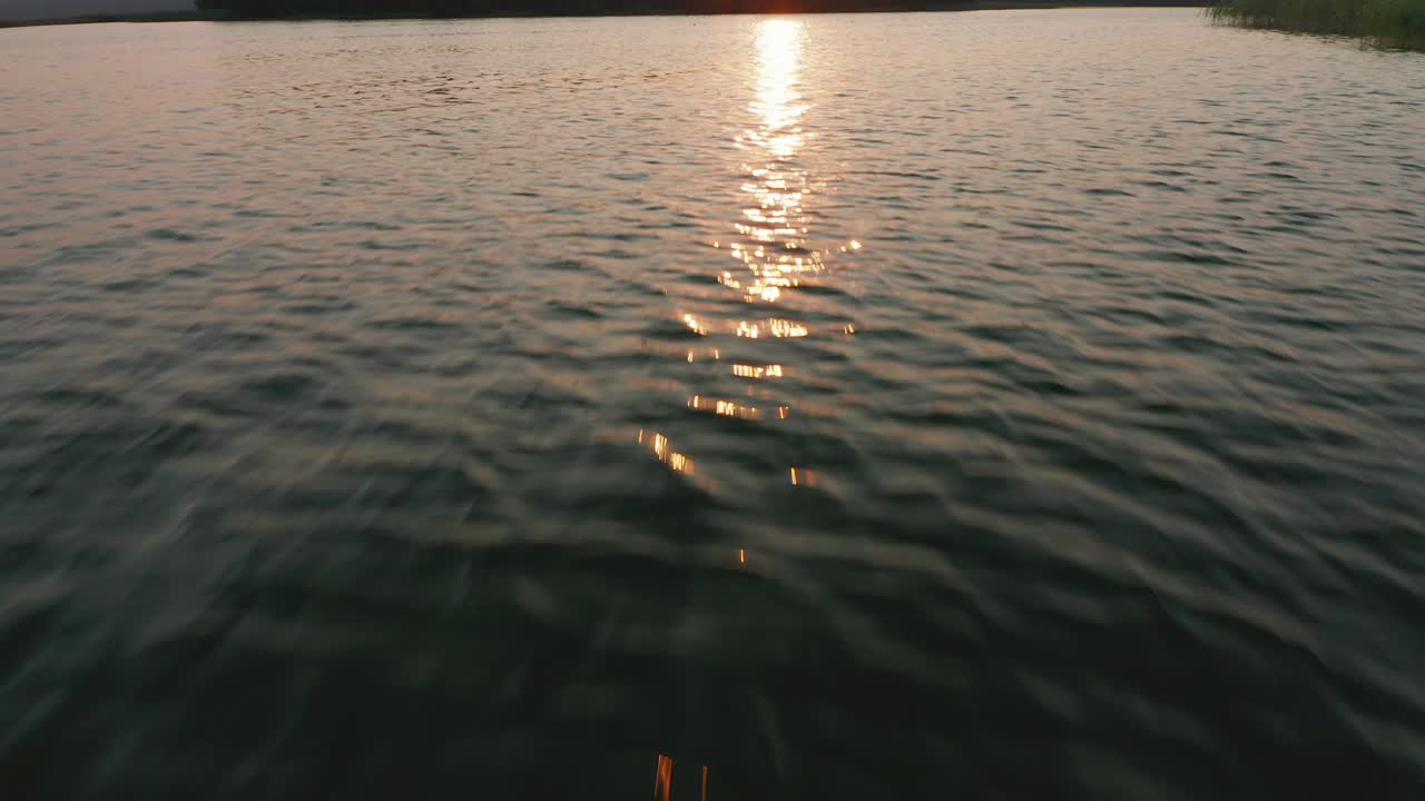 Camera dolly in: over disturbed lake water surface