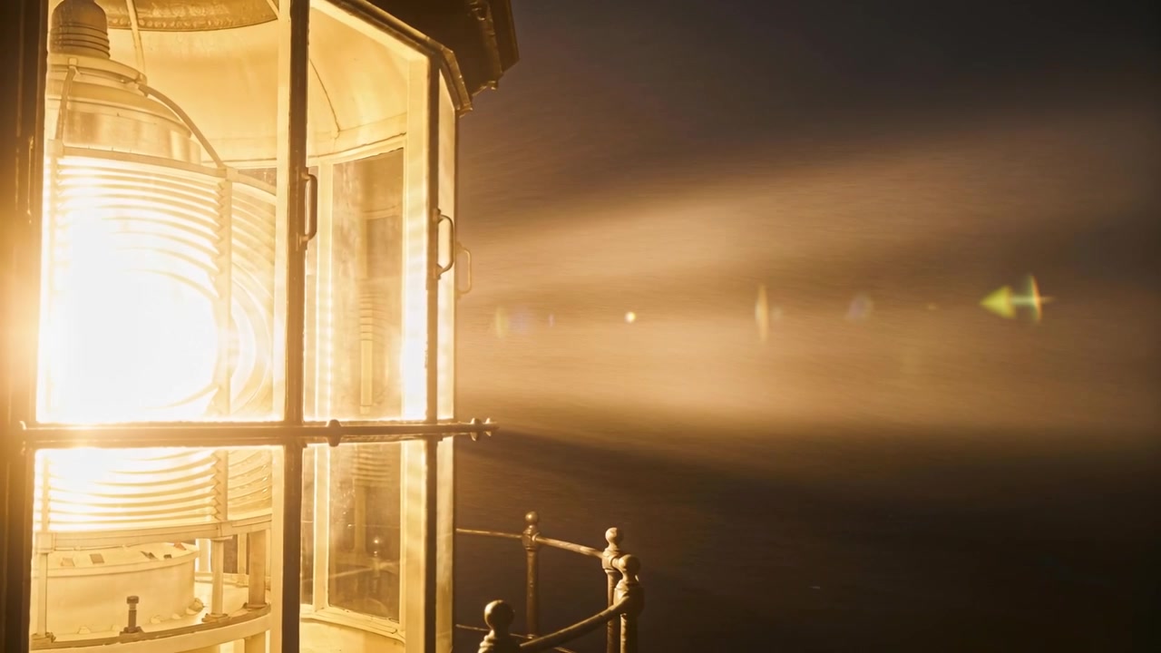 Rotating Fresnel lens projecting beam across night, guiding ships, showing railing, copy space