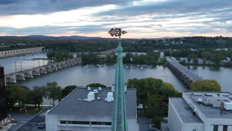 spire with susquehanna river and bridges in the background during sunset in harrisburg, pennsylvania