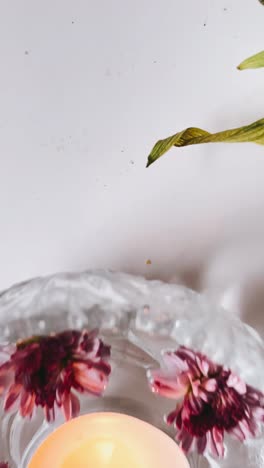 floating flowers and candle in glass bowl