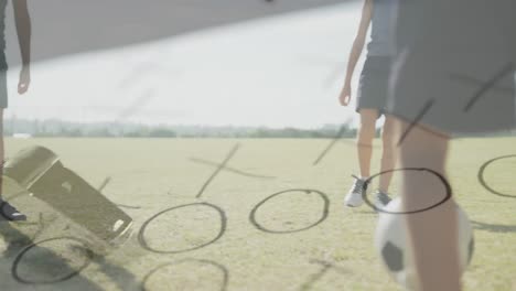 animation of whistle and game plan over happy diverse schoolboys playing football