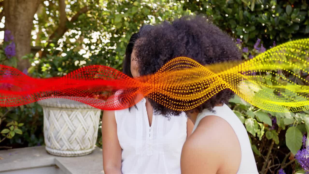 Mature woman listening while woman on right leaning, animated dot wave sweeping, showing tech demo